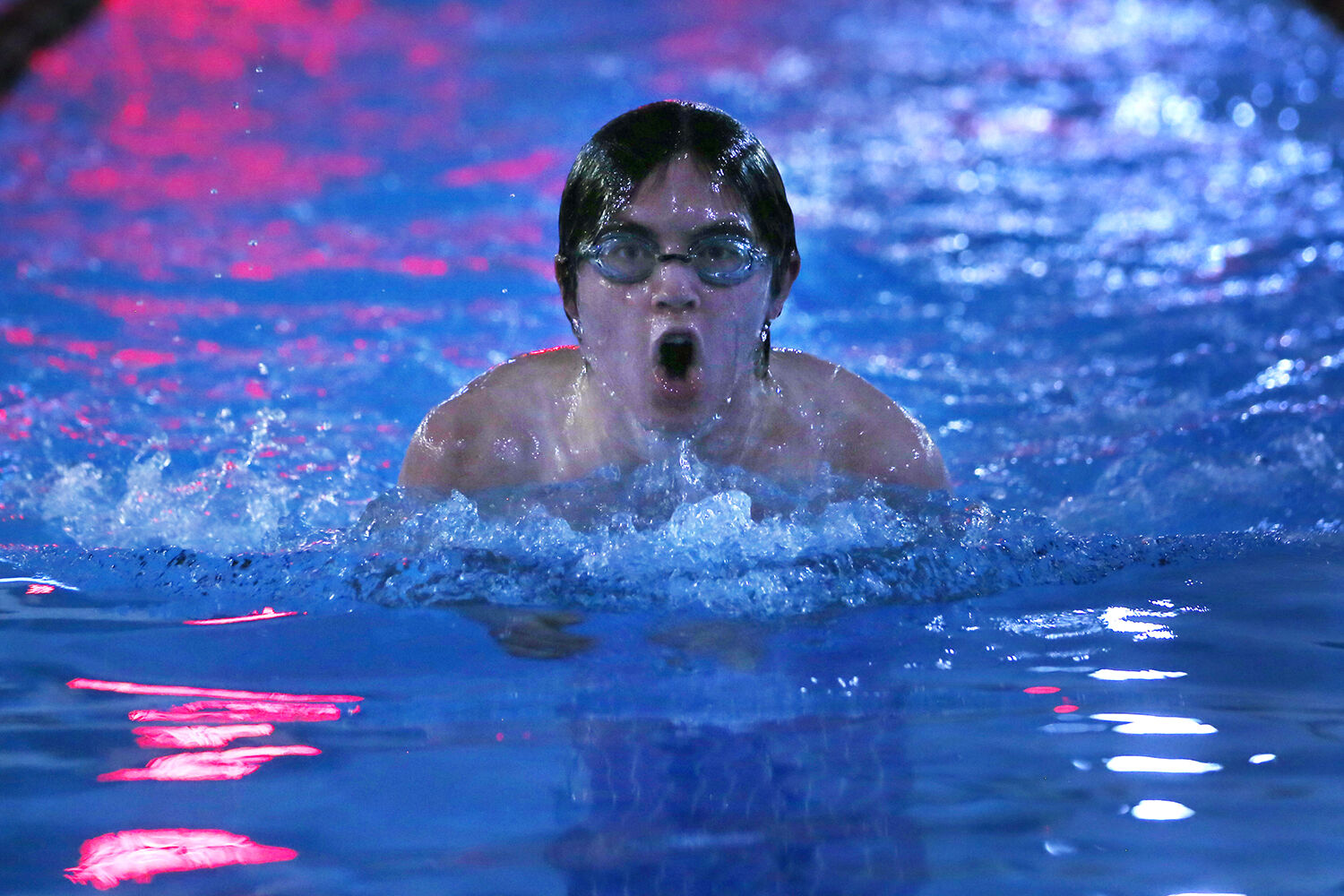 Andy Wages breaths while rising out of the water